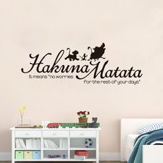 a bedroom with a wall decal that says hakina matata