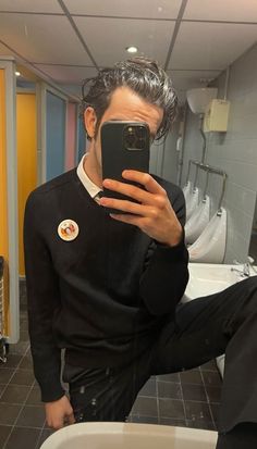 a man taking a selfie in the bathroom