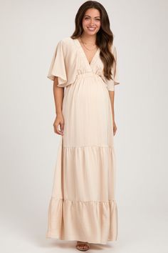 Beige V-Neck Flutter Sleeve Tiered Maternity Maxi Dress Chic Flowy V-neck Maternity Dress, V-neck Maternity Dress For Brunch, Feminine V-neck Maternity Dress For Summer, Elegant Maxi Length Maternity Dress For Beach, Elegant Maxi Maternity Dress For Beach, Elegant Beach Maternity Maxi Dress, Flowy Maxi-length Maternity Dress For Beach, Flowy Maternity Maxi Dress For Beach, Flowy Maxi Length Maternity Dress For The Beach