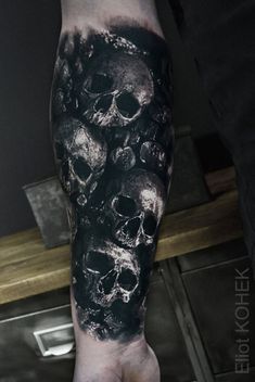 a man's arm with skulls on it