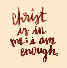 the words christ is in me i am enough written on a piece of brown paper