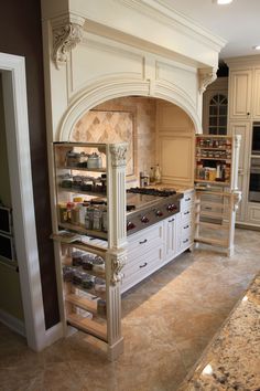 a large kitchen with an oven, stove and counter top in the middle of it