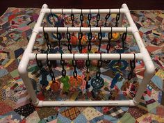 a rack that has several pairs of scissors in it on top of a quilted tablecloth