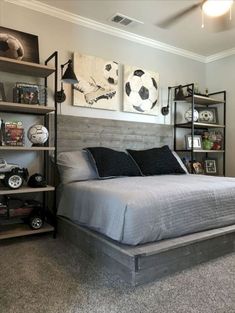 a bedroom with a bed, shelves and pictures on the wall