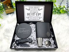 a gift box with two flasks, a bottle opener and a lighter in it