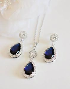 the necklace and earrings are set with blue stones