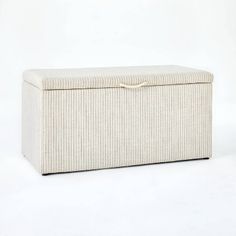 an upholstered storage box is shown on a plain white background, with the lid closed