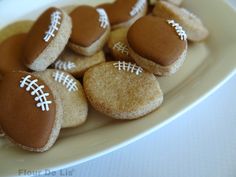 cookies decorated with footballs on a plate