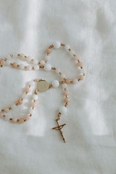 These soft and feminine rosary beads are inspired by the many beautiful characteristics of Mary’s Immaculate Heart: graceful, pure, receptive, strong, and gentle to name a few. Intertwined are tiny gold beads serving as a reminder of her Heavenly Queenship. Our prayer is that this rosary will help conform your heart to that of our Mother’s. This rosary is a part of the Heart Collection, a collection of rosaries inspired by the Holy Hearts of the Holy Family. Gold Necklaces With 8mm Beads For Blessing, Gold Spiritual Rosary For Meditation, Gold Rosary For Meditation, Gold Rosary With 8mm Beads For Meditation, Elegant Healing Rosary With Round Beads, Elegant Rosary With Round Beads For Healing, Elegant Healing Rosary, Gold Rosary With 8mm Beads For Healing, Spiritual Rose Gold Rosary Bracelet Gift