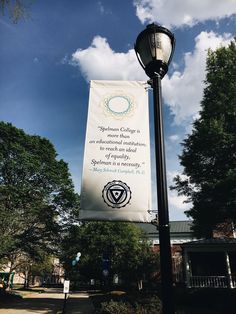 a street light with a banner hanging from it's side