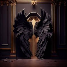 two large black wings sitting on top of a wooden floor in front of a doorway