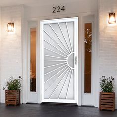 a white front door with two planters on either side and the number 2234