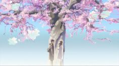 two people standing in front of a tree with pink flowers on it and the sky behind them