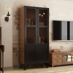 a tall wooden cabinet with glass doors in a living room next to a dresser and tv