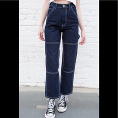 High Rise Relaxed Fit Dark Wash Denim With White Stitching And Slim Leg, 8 Pockets, Belt Loops, Utility Loop, Knee Patch Detailing, And A Zipper With Button Closure. Fabrics: 100% Cotton. Measurements: Size S: 13" Rise, 29" Inseam, 26" Waist. Size M: 13" Rise, 30" Inseam, 27" Waist. Model Is Wearing Size S. Made In: China Blue Relaxed Fit Jeans With Contrast Stitching, Blue Jeans With Contrast Stitching For Fall, Painter Jeans, Jeans Brandy Melville, Brandy Melville Jeans, Denim Cargo Pants, Knee Patches, Corduroy Jeans, Flare Leg Jeans