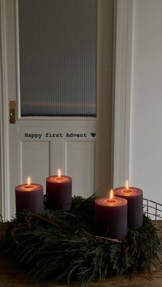 some candles are sitting in front of a door