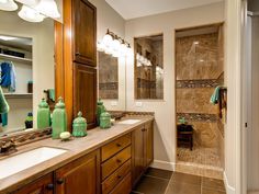 a bathroom with two sinks and large mirrors