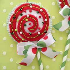 a red and white pinwheel ornament with candy canes