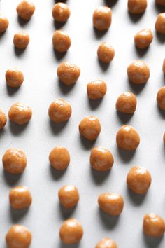 some kind of food that is sitting on a table with it's peanut coatings