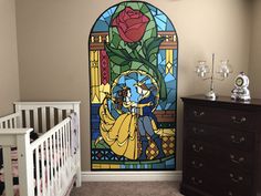 a stained glass window in the corner of a room with a crib and dresser