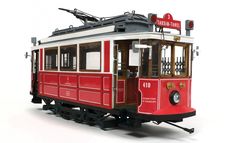 a red and white trolley car sitting on top of a white floor next to a stop sign