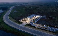 an aerial view of a building on the side of a road