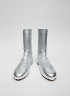 First introduced on our Spring 2024 Runway, the Borg Sock Boot receives a refresh for the turnover of seasons. Now available in two metallic colorways, our newest iteration will be the style you reach for, dialing up or toning down your look, depending on the desired vibe this Winter season. 100% Lamb Leather (Upper), 100% Cotton (Sock), 100% Cuoio Leather (Outsole) Style Number: SW24BO2118 Available in: Gold, Silver Metallic Socks, The Borg, 2024 Runway, Sock Boot, Silver Shoes, Shoes Outlet, Spring 2024, Shoes Heels Boots, Winter Season