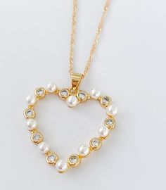 "Pearl heart necklace MATERIAL AND SIZE 18k Gold plated Heart Pearls and cubic zirconia Heart size: 2.5cm Chain length: 45cm or 18\" If you have questions about the product, feel free to reach me out. Don't forget to check out my other items in the store: Https://www.etsy.com/shop/nyahwithlove" Heart Pendant Necklace With Charm For Party, Mother's Day Heart Pendant Necklace For Party, Mother's Day Party Heart Pendant Necklace, Open Heart Necklace For Valentine's Day Party, Valentine's Day Open Heart Necklace For Party, Party Heart Pendant Necklace With Heart Charm, Heart Charm Necklace For Party, Heart Necklace With Pearl Chain For Gift, Open Heart Charm Necklace For Party