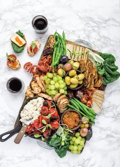 a platter filled with different types of food on top of a marble countertop