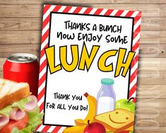 a lunch card with an image of a sandwich and soda on the table next to it