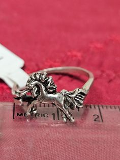 This sterling silver UNICORN H-6U ring is hand crafted and made in Minnesota.  It has good detailing of the design.  This ring is sold in sizes from 8 to 8 1/2 USA scale.  Please shop my other items on ETSY in the AllasIFoundIt LLC store.  Many different animals, flowers, and unique designs on the sterling silver band. Fairytale Ring, Unicorn Ring, Unicorn Jewelry, Animals Flowers, Silver Eagles, Animal Rings, Statement Ring Silver, Fantasy Jewelry, Sterling Silver Bands