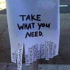 a white sign with black writing on it that says take what you need written in different languages