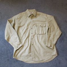 Nwot Wrangler Rugged Wear Large Beige Button Front Shirt Shoulder Patch Shooting Button Is Not Missing, Just Wasnt Buttoned When Pix Was Taken Large Front Pocket 100% Cotton Back Neck To Bottom: 33.5" Pit To Pit: 23" Very Good Quality Smoke Free Home Wrangler Shirts, Button Front Shirt, Casual Shirts For Men, Casual Button Down Shirts, Front Pocket, Good Quality, Mens Shirts, Man Shop, How To Wear