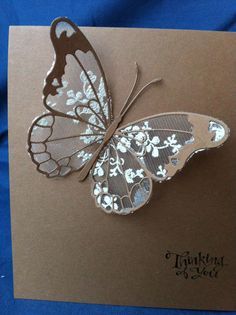 a brown card with a white butterfly on it