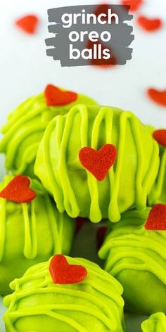 some green and red heart shaped cookies on a white surface with the words crunch oreo balls above it