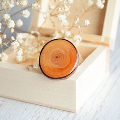 This sterling silver ring is made by nature with my little help :) The gem is made from a natural reclaimed wood with rich grain - fallen tree branch found in the forest. I cut it into slices, carefully sanded and covered the top with a drop of resin. The ring is made from sterling silver and it's adjustable size - minimal ring diameter is 17 mm (0,67 in).  Wooden gem dimensions: ~ 28 mm (1,1 in) You will receive this ring in a natural JEWELRY BOX, carefully packed in brown paper and tied with a Nature-inspired Natural Wood Jewelry With Variations, Nature-inspired Natural Wood Jewelry, Nature-inspired Wooden Jewelry Gift, Natural Wood Jewelry With Variations For Gift, Round Wood Jewelry As A Gift, Natural Wood Jewelry With Variations For Gifts, Natural Wood Jewelry With Variations As A Gift, Natural Wood Jewelry With Natural Variations As Gift, Round Wooden Jewelry For Gifts