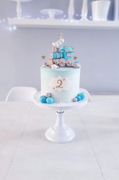 a blue and white cake sitting on top of a table