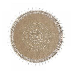 a round rug with white pom poms on the bottom and an intricate design