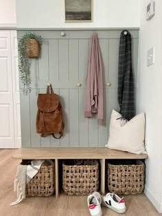 Arid gray painted DIY shiplap with a brushed brass and marble hooks for backpacks and jackets. A low thin profile floating bench with woven storage baskets underneath is the perfect spot for kids to put on and take of their shoes. Entryway Mirror And Coat Hook, Double Hook Mudroom, Flat Mudroom Wall, Shiplap Wall Front Entrance, Budget Mudroom Ideas, Diy Entry Wall With Hooks, Diy Entryway Bench With Hooks, Diy Entry Bench And Hooks, Shiplap Entryway With Bench