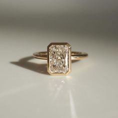 a diamond ring sitting on top of a table