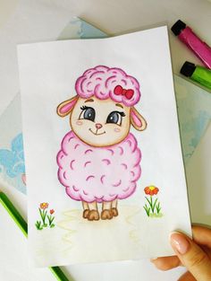 a drawing of a pink sheep with hearts on it's head, sitting next to markers and pencils