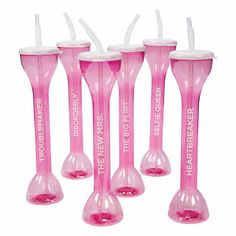 four pink toothbrush holders with white tops