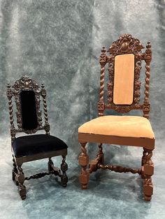 two old fashioned chairs with mirrors on them