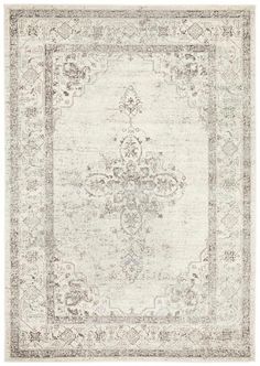 an antique style rug in white and grey tones