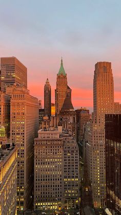 the city skyline is lit up at night, with skyscrapers in the foreground