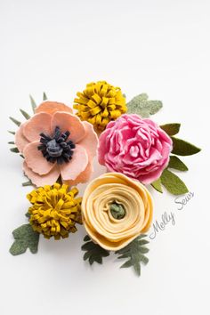 three different colored flowers with leaves on white background