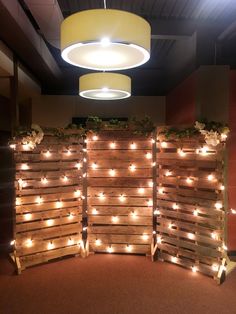 several wooden pallets with lights on them in the middle of an office lobby area