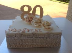 a close up of a cake on a table with the number 80 written in frosting