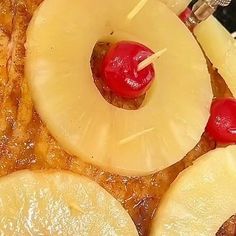 pineapple slices and cherries are arranged in the shape of a spiral on top of pancakes