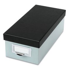 a black and silver box with a white label on the lid is sitting against a white background